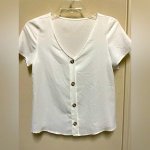Small white blouse with buttons sewed on